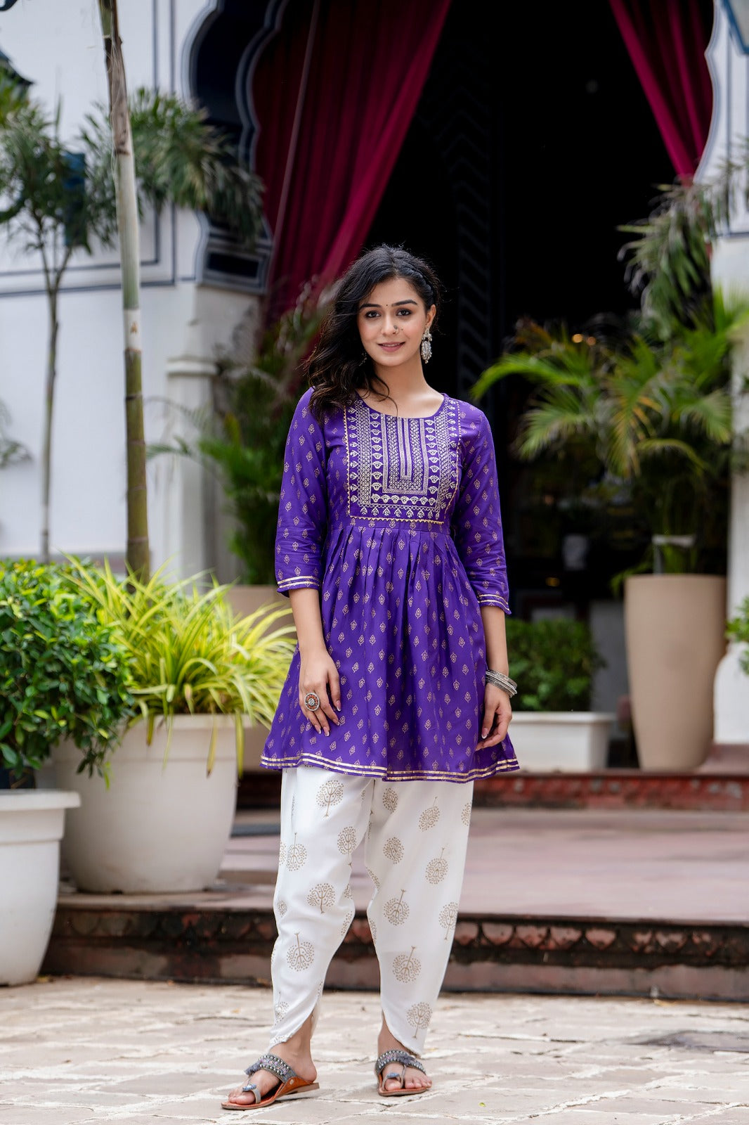 Voilet ethinc motif gold printed kurti with embroidery on yoke and gota lace detailing and gold printed dhoti pant which has full elasticated waistband