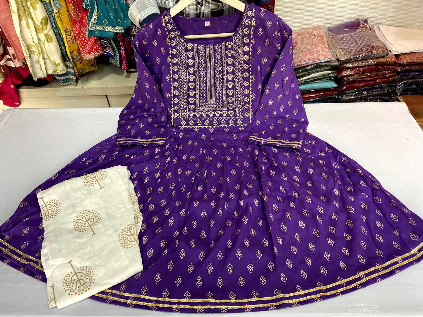 Voilet ethinc motif gold printed kurti with embroidery on yoke and gota lace detailing and gold printed dhoti pant which has full elasticated waistband