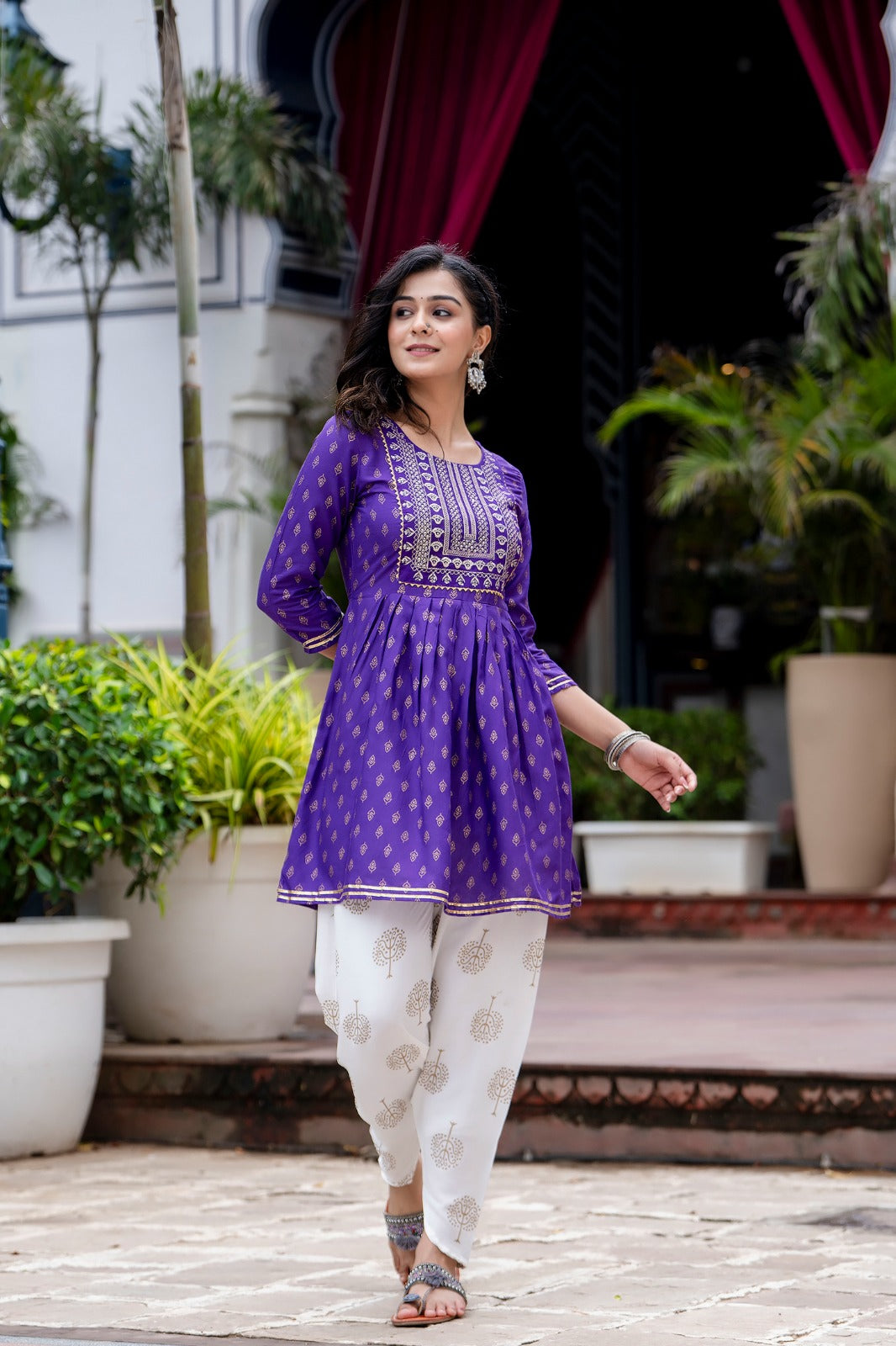 Voilet ethinc motif gold printed kurti with embroidery on yoke and gota lace detailing and gold printed dhoti pant which has full elasticated waistband