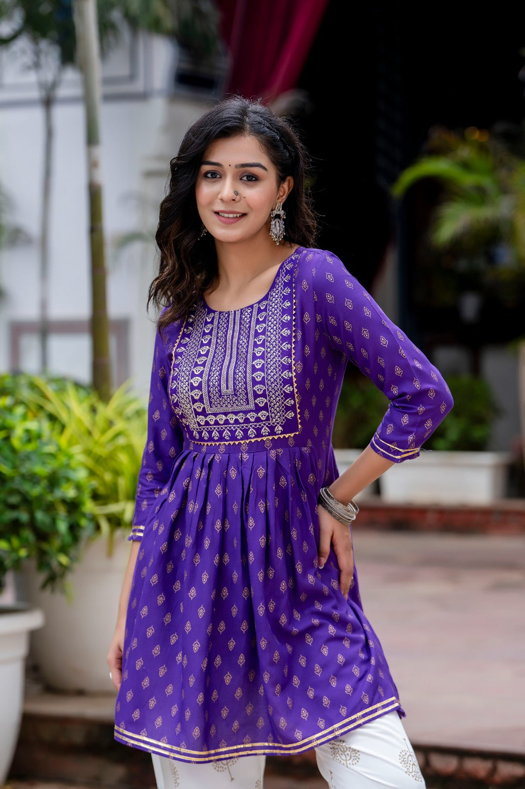 Voilet ethinc motif gold printed kurti with embroidery on yoke and gota lace detailing and gold printed dhoti pant which has full elasticated waistband
