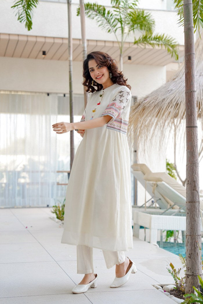 White aline kurta Style made from high-quality cotton, embellished with sequance embroidery work on hand sleeves and side line and paired with matching pant