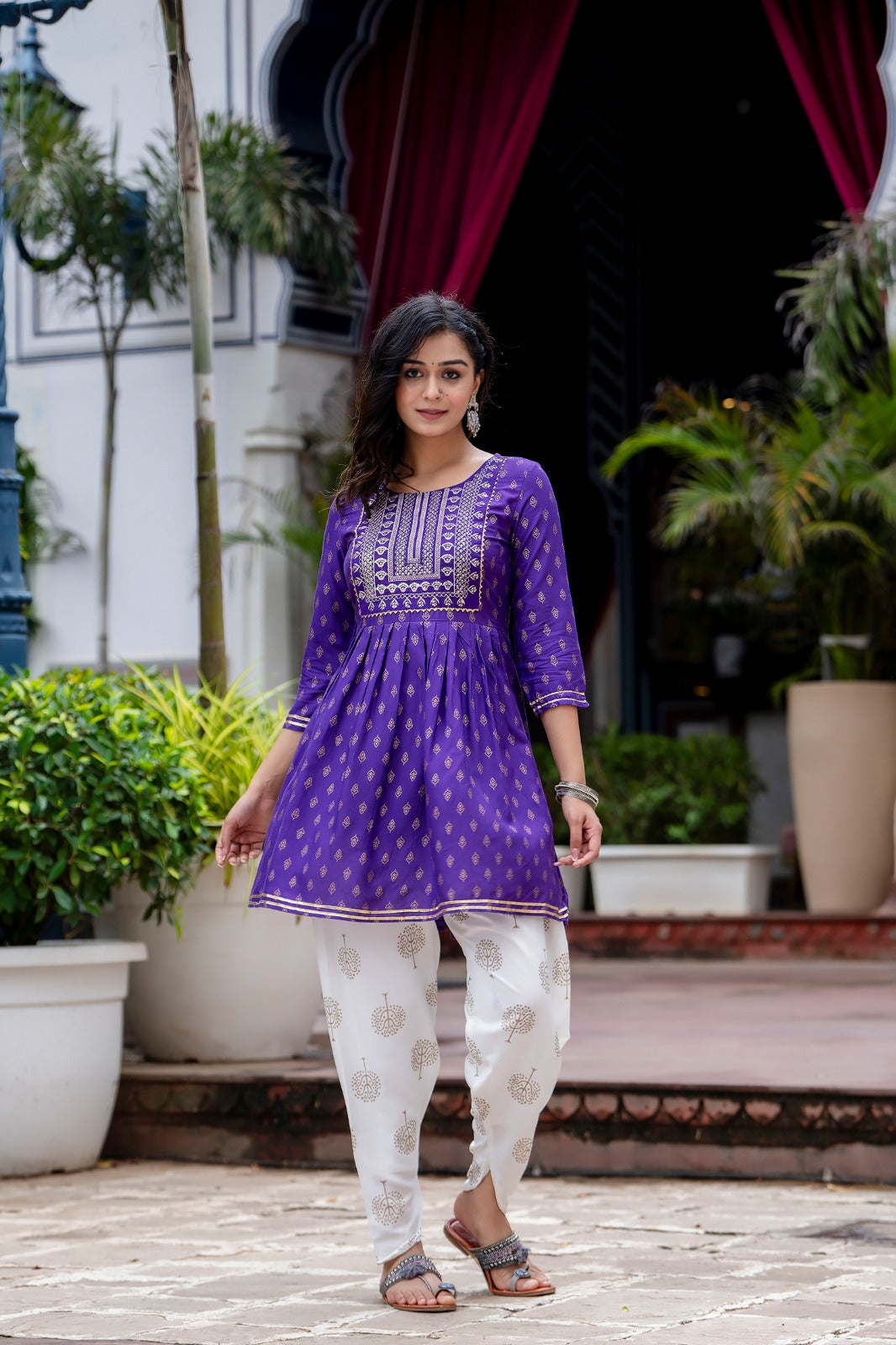 Voilet ethinc motif gold printed kurti with embroidery on yoke and gota lace detailing and gold printed dhoti pant which has full elasticated waistband