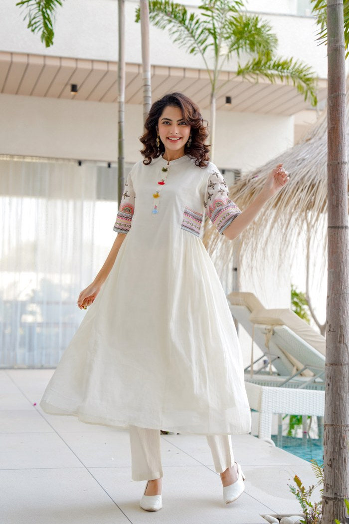 White aline kurta Style made from high-quality cotton, embellished with sequance embroidery work on hand sleeves and side line and paired with matching pant