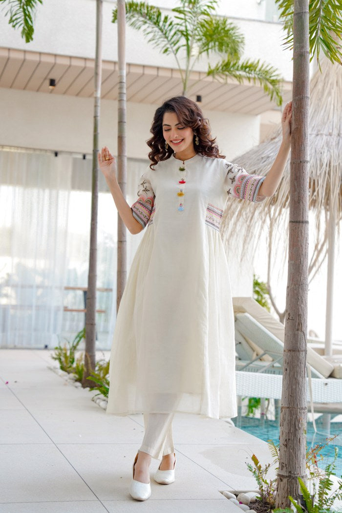 White aline kurta Style made from high-quality cotton, embellished with sequance embroidery work on hand sleeves and side line and paired with matching pant